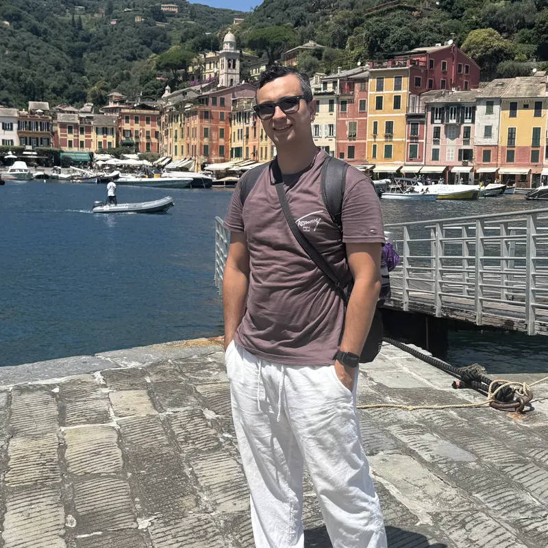 Abozar on the harbour promenade in Portofino with colourful houses behind